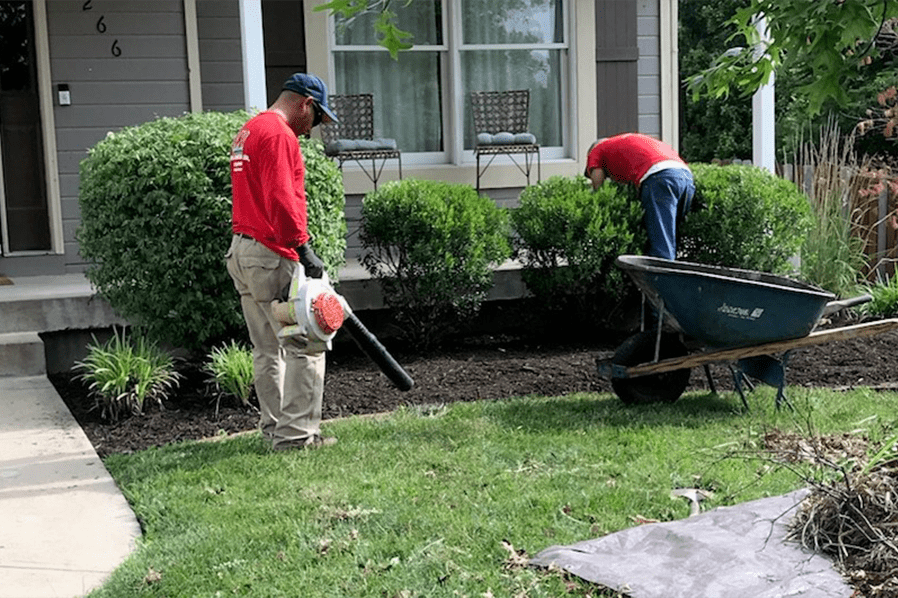 Two Men Working On Garden Area