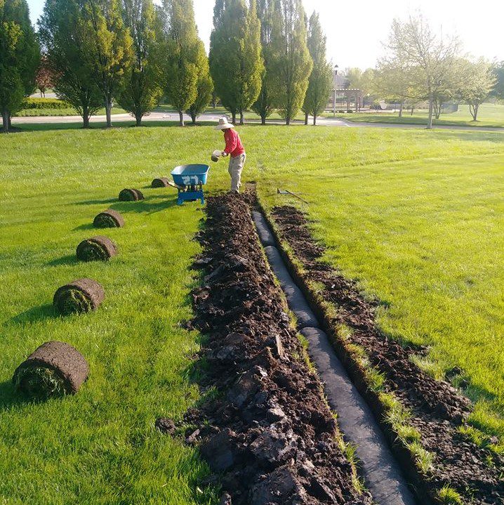 Man Creating A Drainage For Soil Absorption